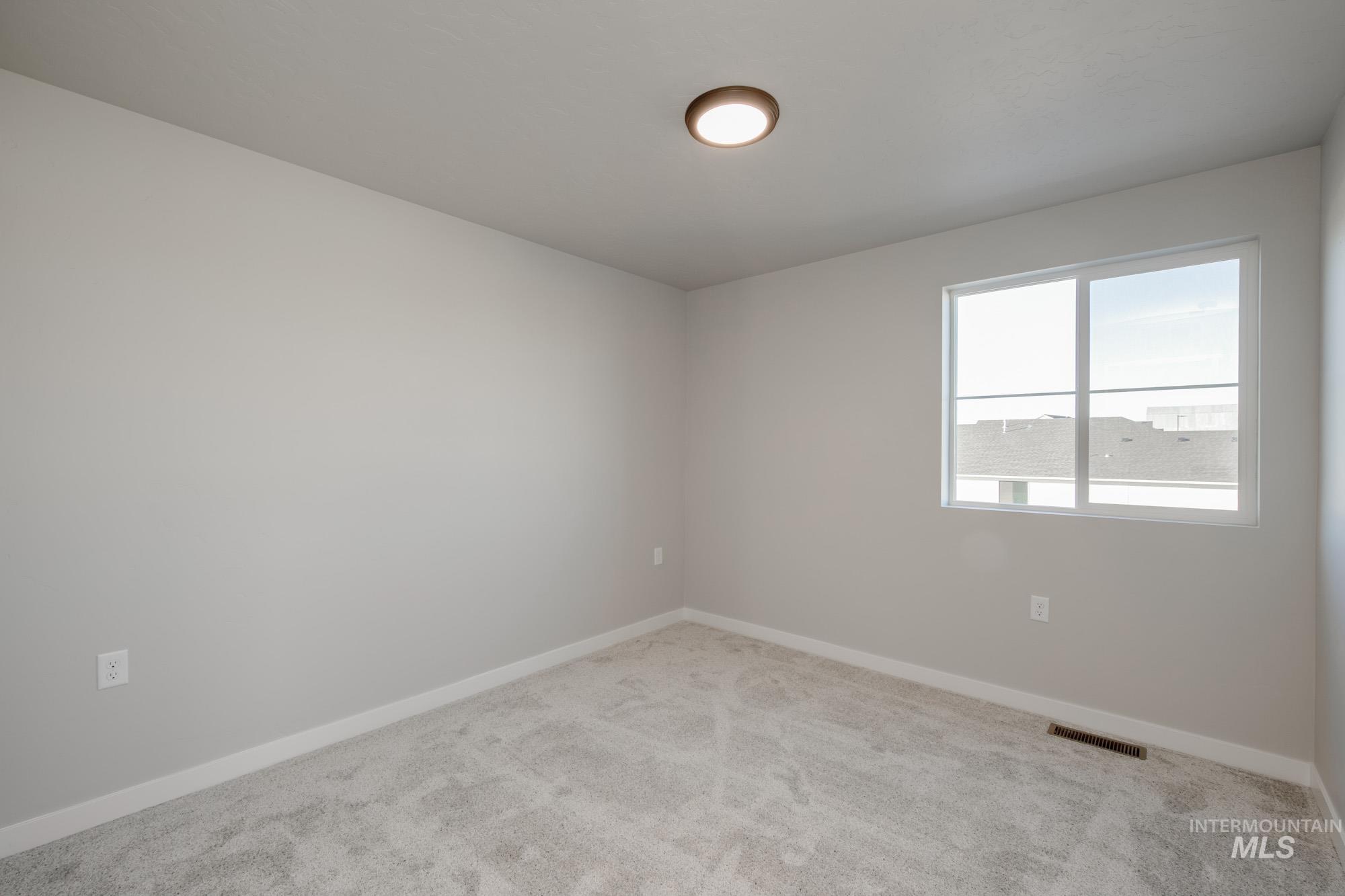 3210 South Maple Rnch Way Nampa, ID 83686 - Photo 21 of 22 Unfurnished room featuring baseboards and carpet