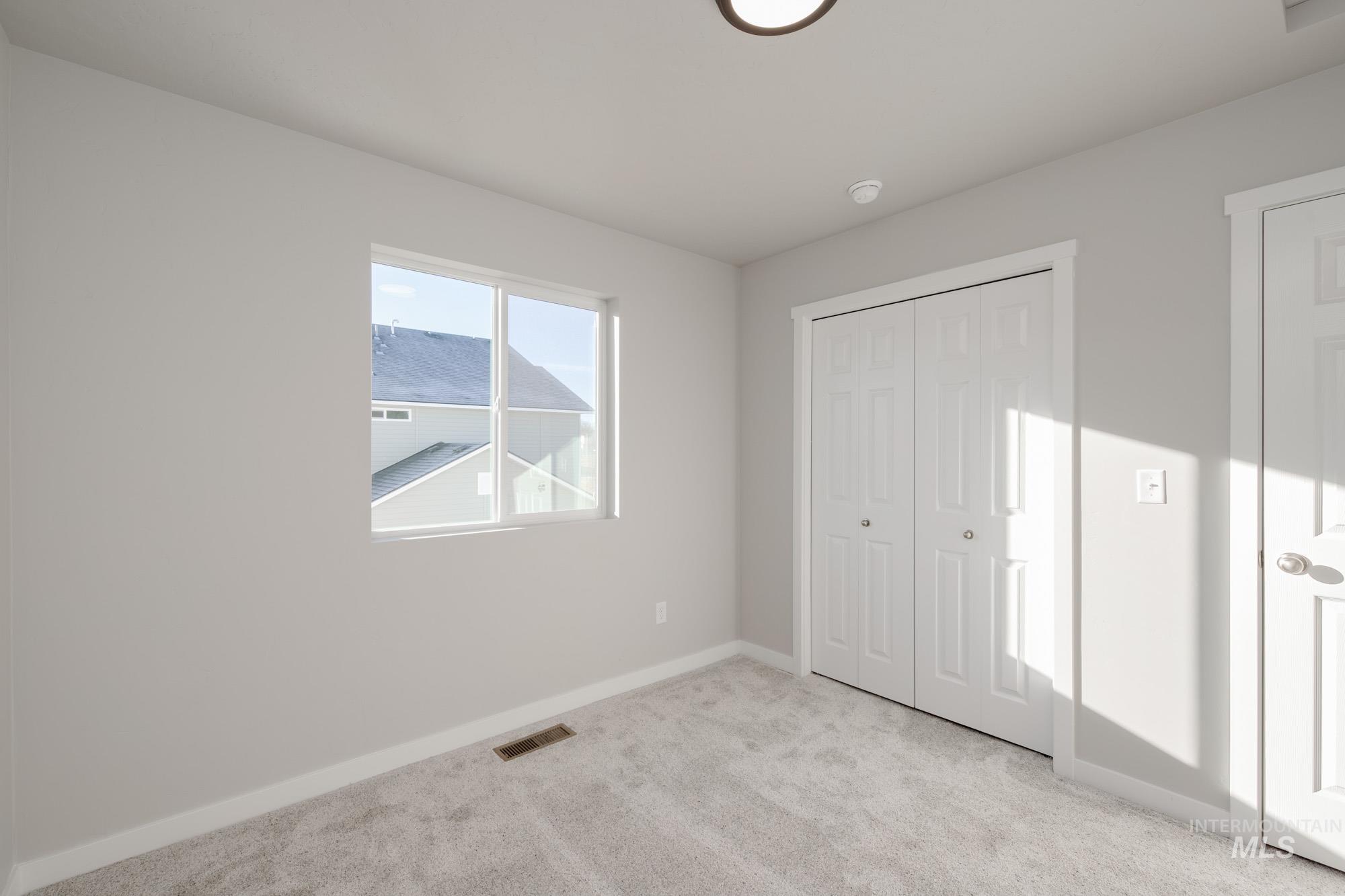 3210 South Maple Rnch Way Nampa, ID 83686 - Photo 22 of 22 Unfurnished bedroom featuring light colored carpet and a closet