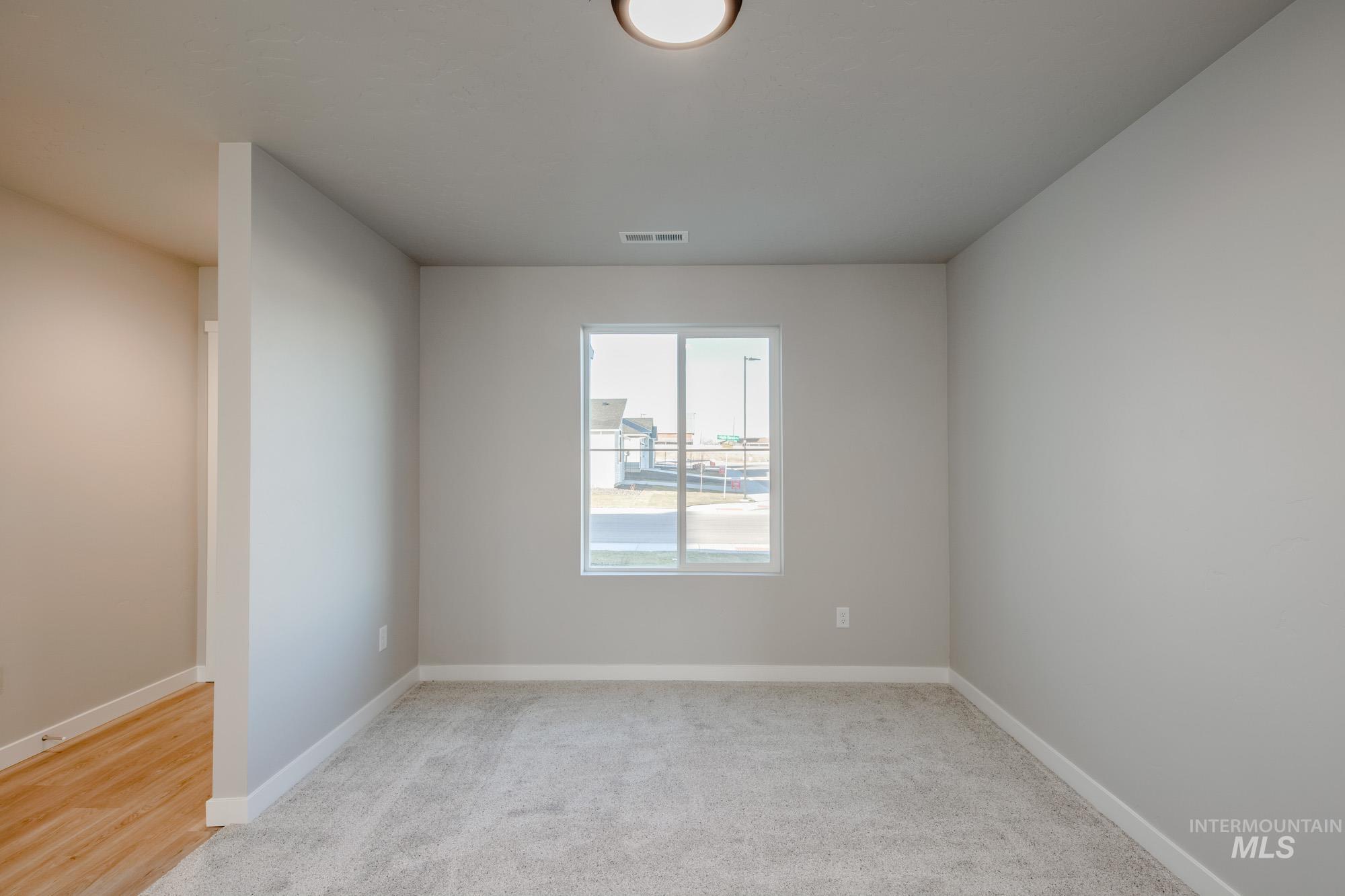 3210 South Maple Rnch Way Nampa, ID 83686 - Photo 4 of 22 Empty room with light carpet and baseboards