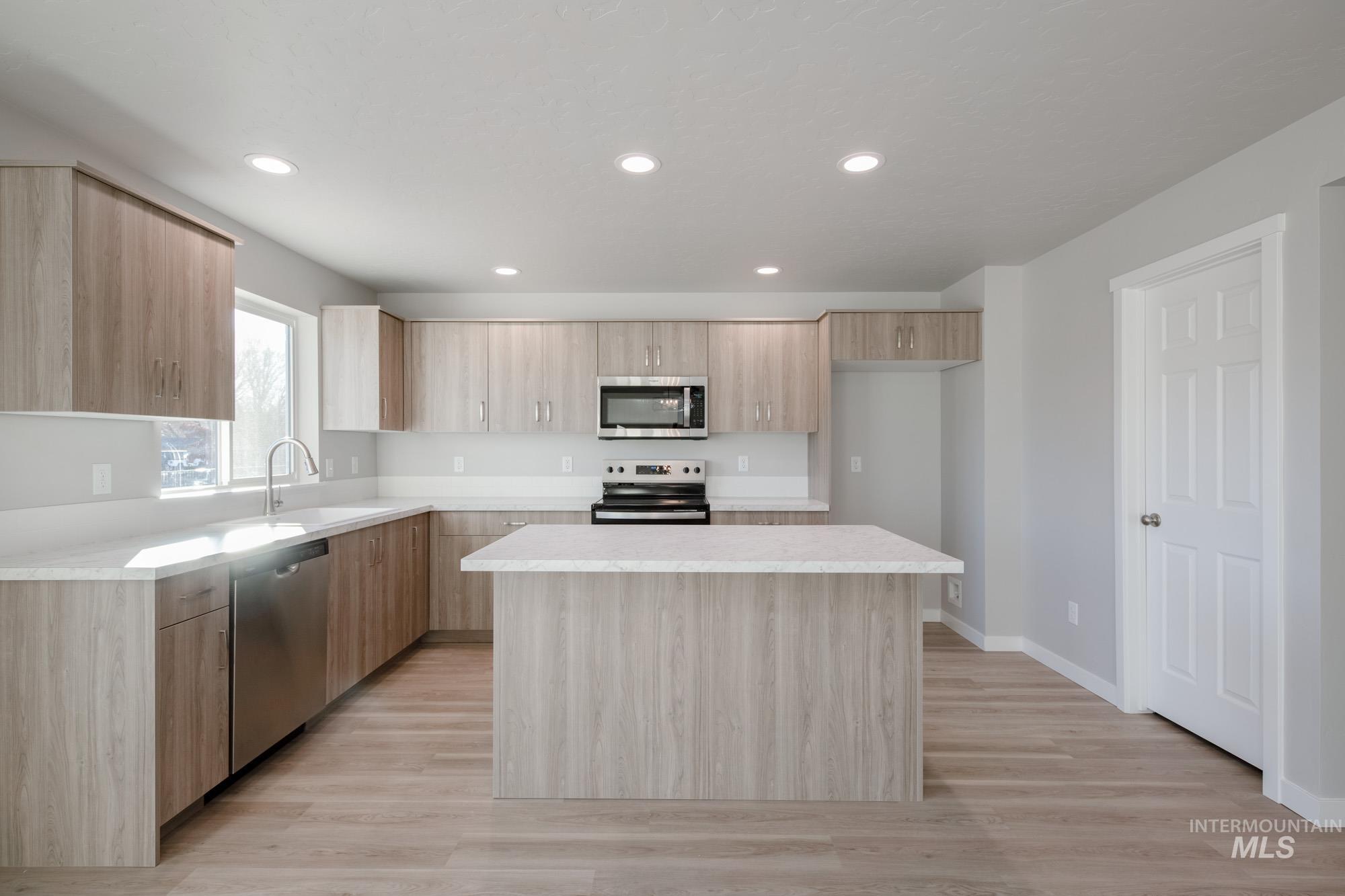 3210 South Maple Rnch Way Nampa, ID 83686 - Photo 9 of 22 Kitchen featuring modern cabinets, light brown cabinets, stainless steel appliances, recessed lighting, and a kitchen island