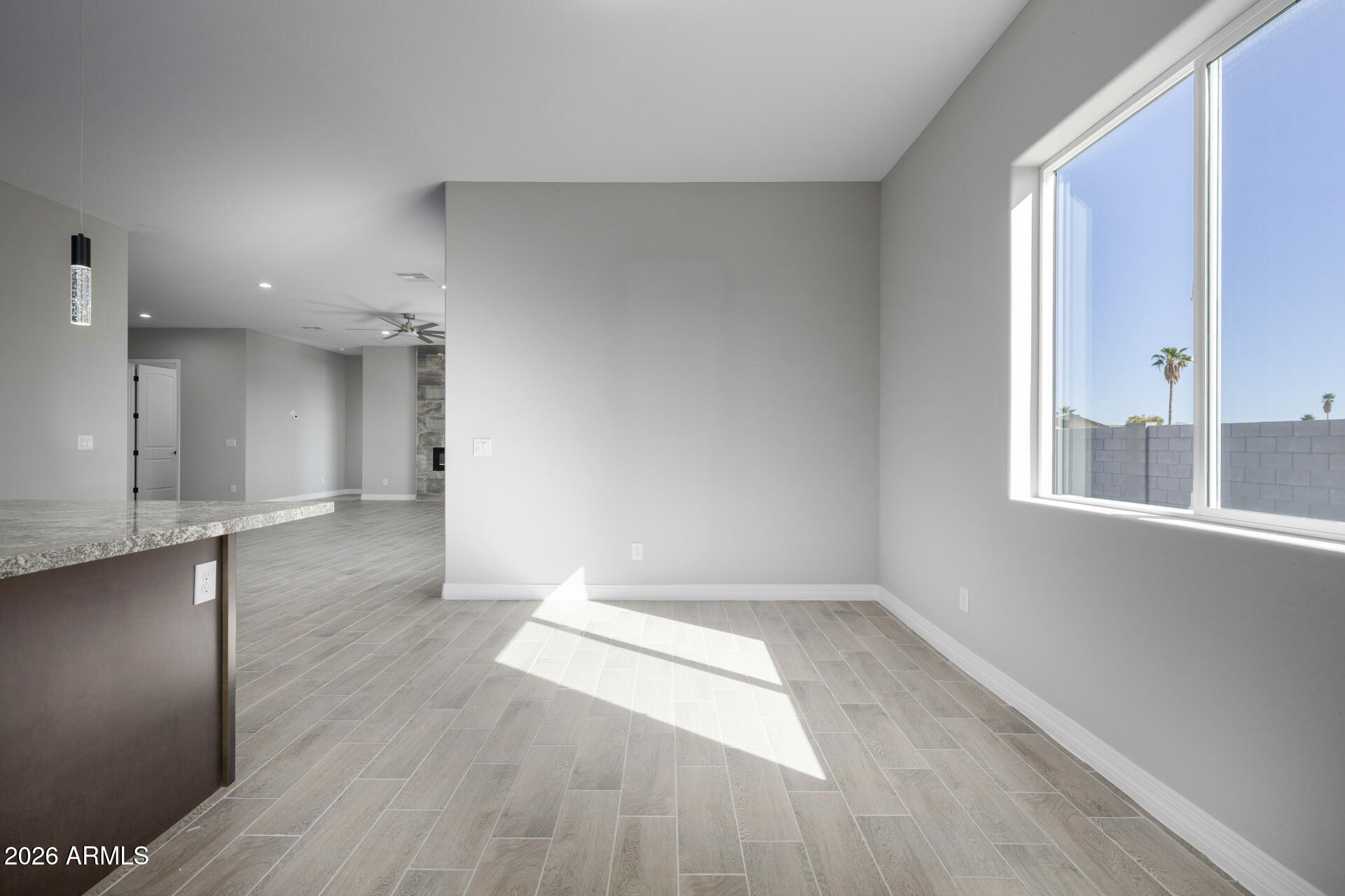 14099 South Vera Cruz Road Arizona City, AZ 85123 - Photo 12 of 32 wooden floor in an empty room with a window