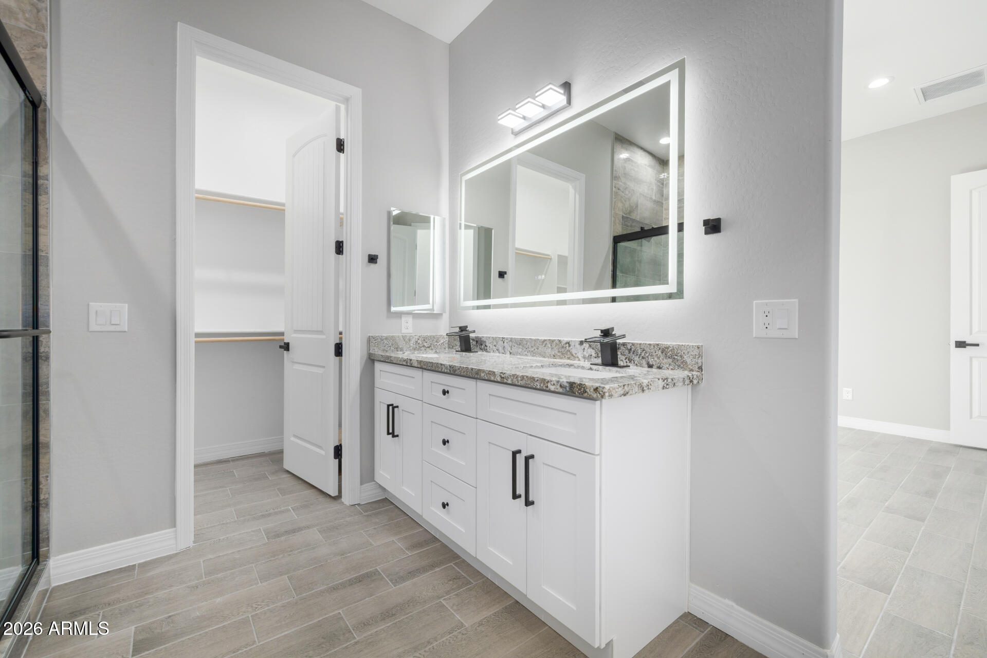14099 South Vera Cruz Road Arizona City, AZ 85123 - Photo 17 of 32 a bathroom with a granite countertop sink and a mirror