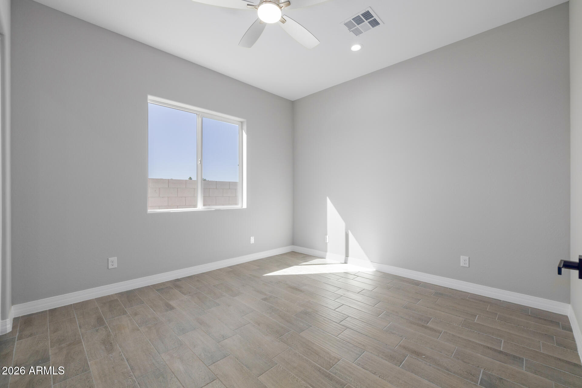 14099 South Vera Cruz Road Arizona City, AZ 85123 - Photo 22 of 32 wooden floor in an empty room with a window