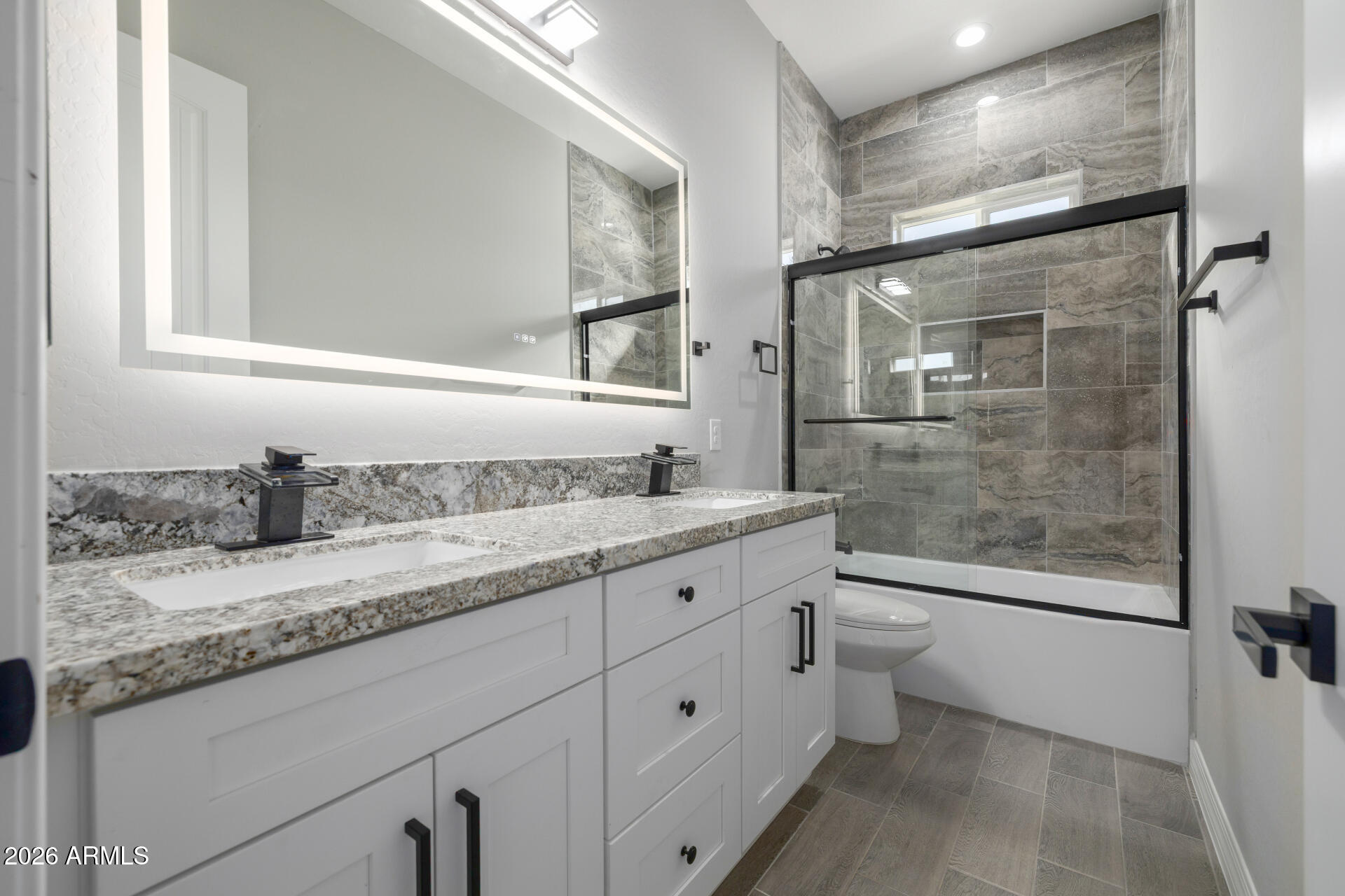 14099 South Vera Cruz Road Arizona City, AZ 85123 - Photo 24 of 32 a bathroom with a granite countertop sink a toilet a mirror and shower