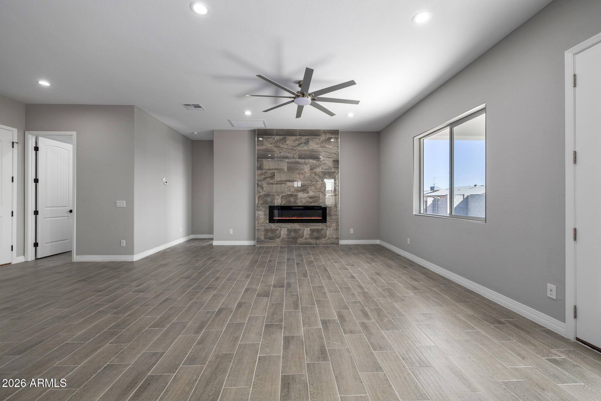 14099 South Vera Cruz Road Arizona City, AZ 85123 - Photo 7 of 32 wooden floor in an empty room with a window