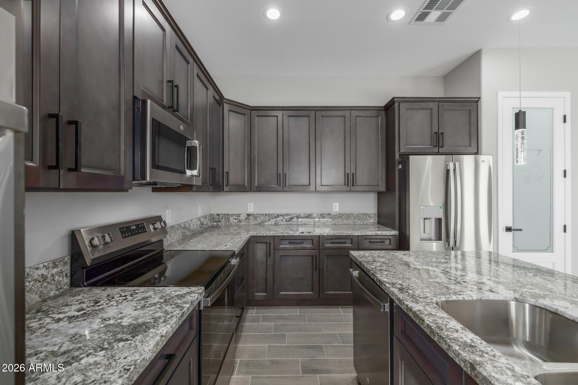 14099 South Vera Cruz Road Arizona City, AZ 85123 - Photo 10 of 32 a kitchen with a stove sink and refrigerator