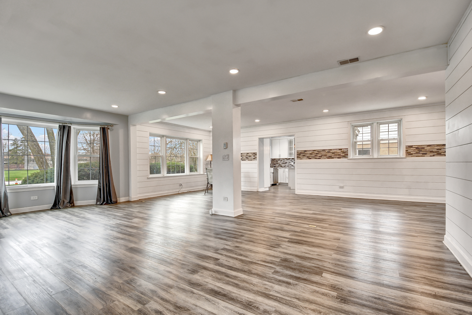 2425 Flossmoor Road Flossmoor, IL 60422 - Photo 4 of 21 a view of an empty room with wooden floor and a kitchen