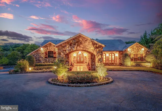 a view of a house with a swimming pool and a yard