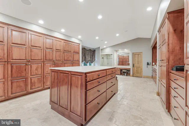 a spacious bedroom with a large bed and a dresser