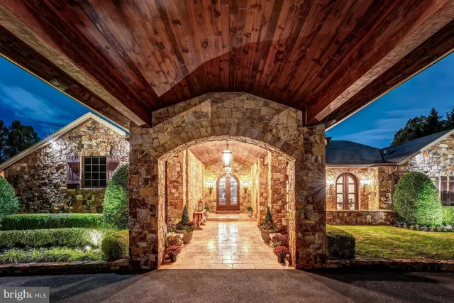 a view of a livingroom with furniture a chandelier and wooden floor