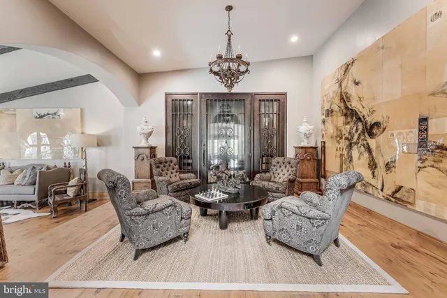 a living room with patio furniture and a large window