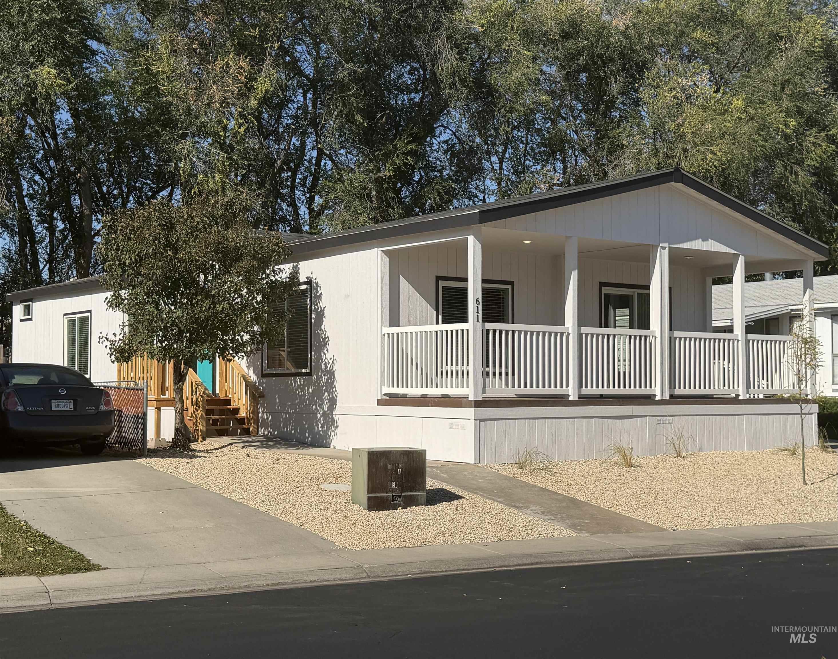 611 North Timathy Road Boise, ID 83713 - Photo 4 of 28 White siding exterior with a covered porch and white railing
