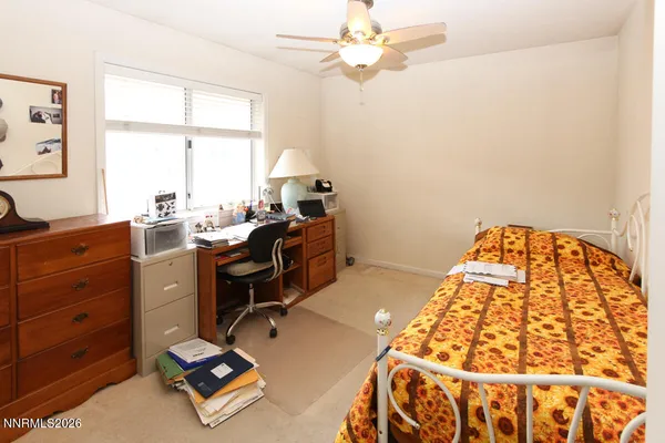 a view of a workspace with furniture and a window