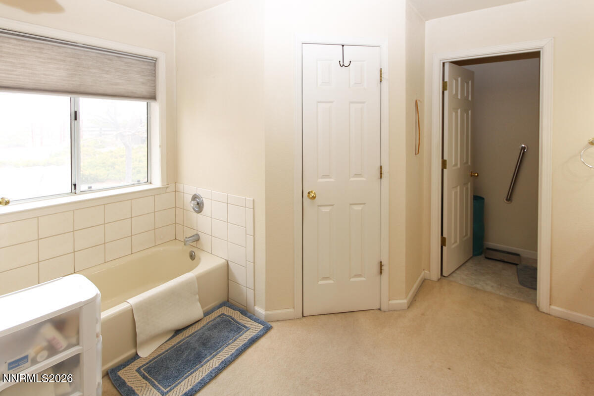 16 Mesa Drive Smith Valley, NV 89444 - Photo 18 of 33 a bathroom with a tub a window and a shower