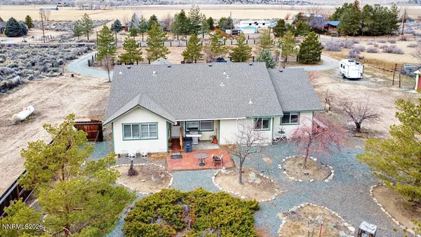an aerial view of a house with swimming pool garden and patio