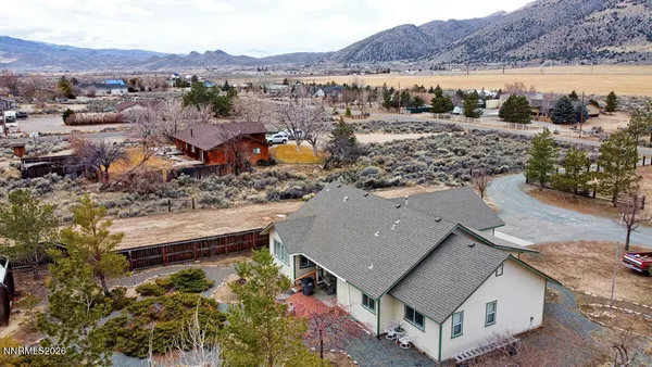 an aerial view of houses with a lake