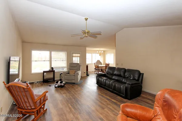 a living room with furniture ceiling fan and a window