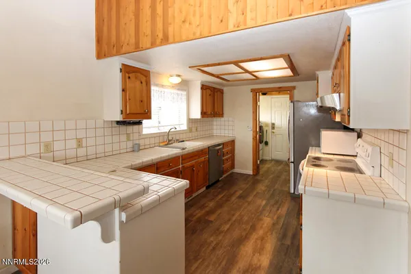 a kitchen that has a sink and a stove in it