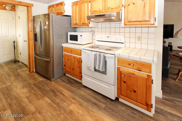a kitchen with stainless steel appliances a refrigerator stove and sink