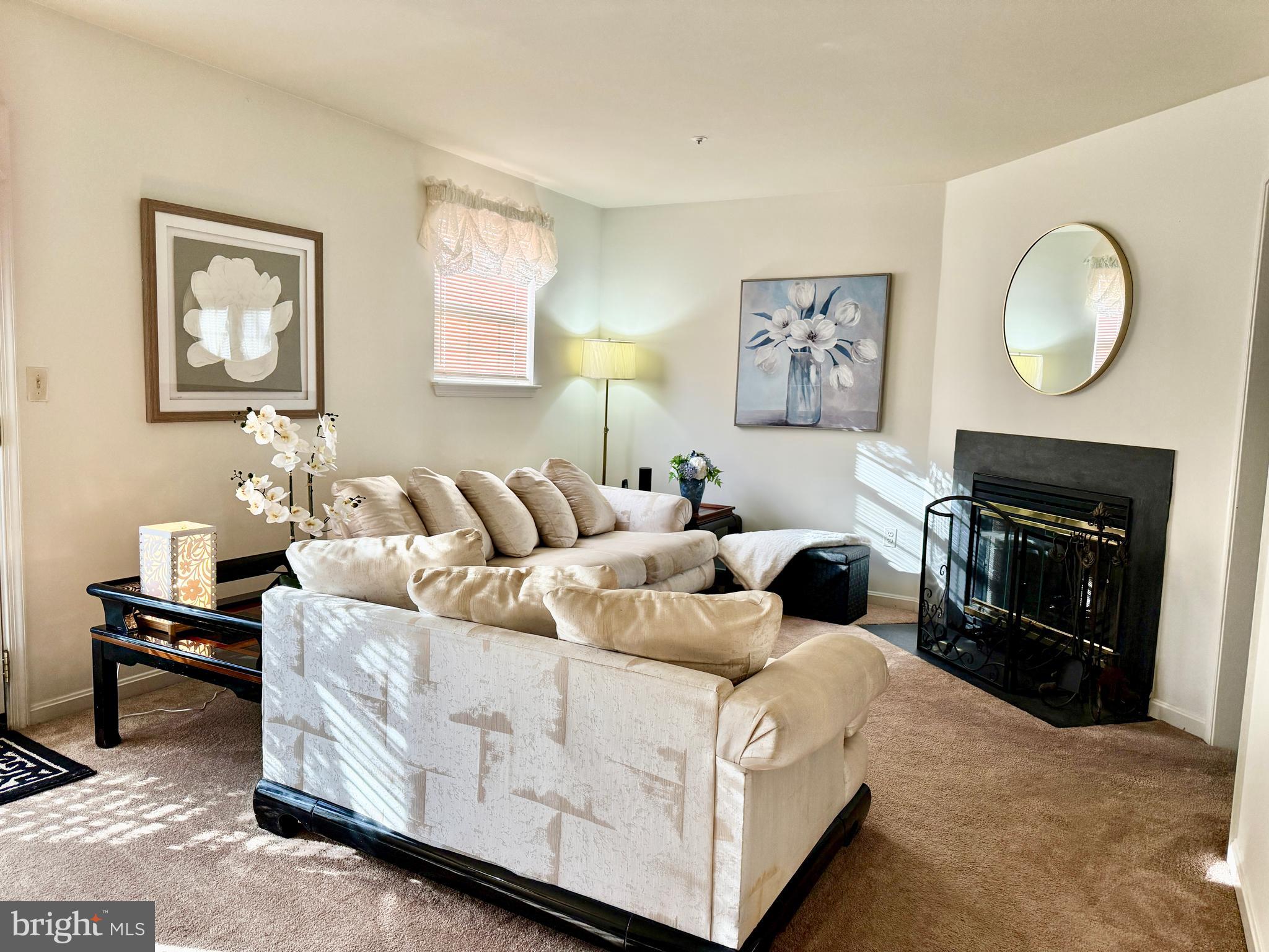 2230 Conquest Way Odenton, MD 21113 - Photo 12 of 47 a living room with furniture a mirror and a fireplace