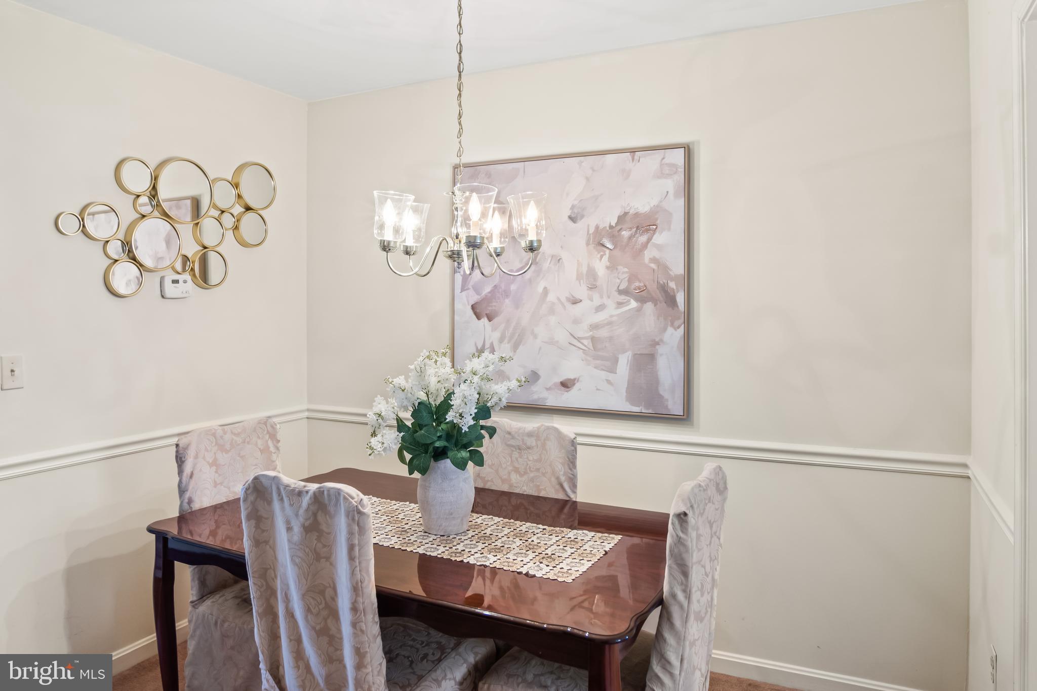 2230 Conquest Way Odenton, MD 21113 - Photo 14 of 47 a dining room with furniture a chandelier and wooden floor