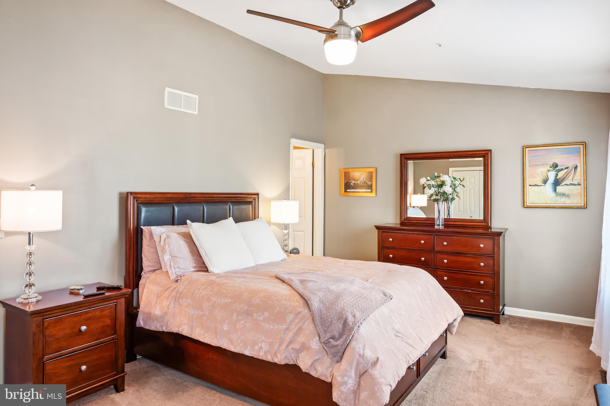2230 Conquest Way Odenton, MD 21113 - Photo 27 of 47 a bedroom with a bed and a lamp on dresser