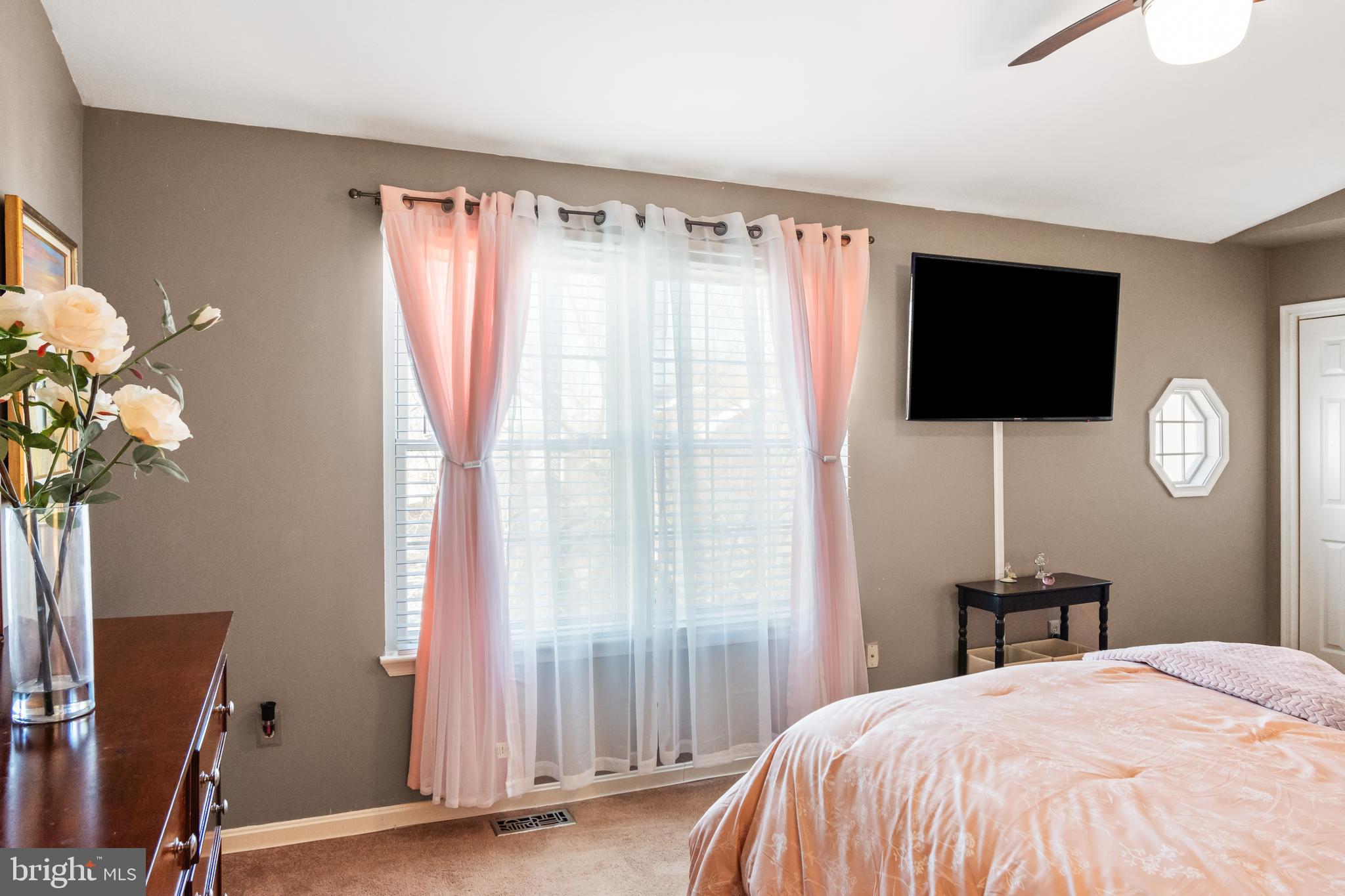 2230 Conquest Way Odenton, MD 21113 - Photo 29 of 47 a bedroom with a bed a flat screen tv and a window