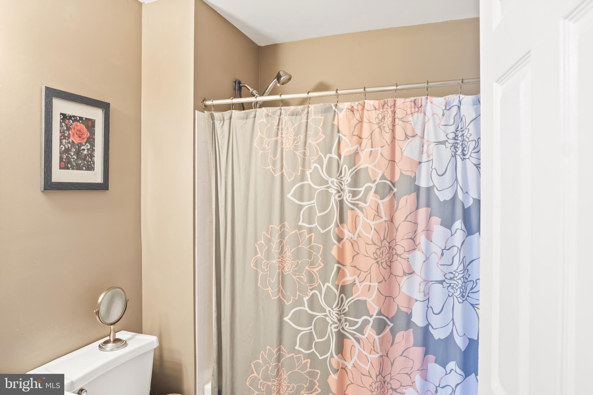 2230 Conquest Way Odenton, MD 21113 - Photo 32 of 47 a bathroom with a toilet and a shower curtain