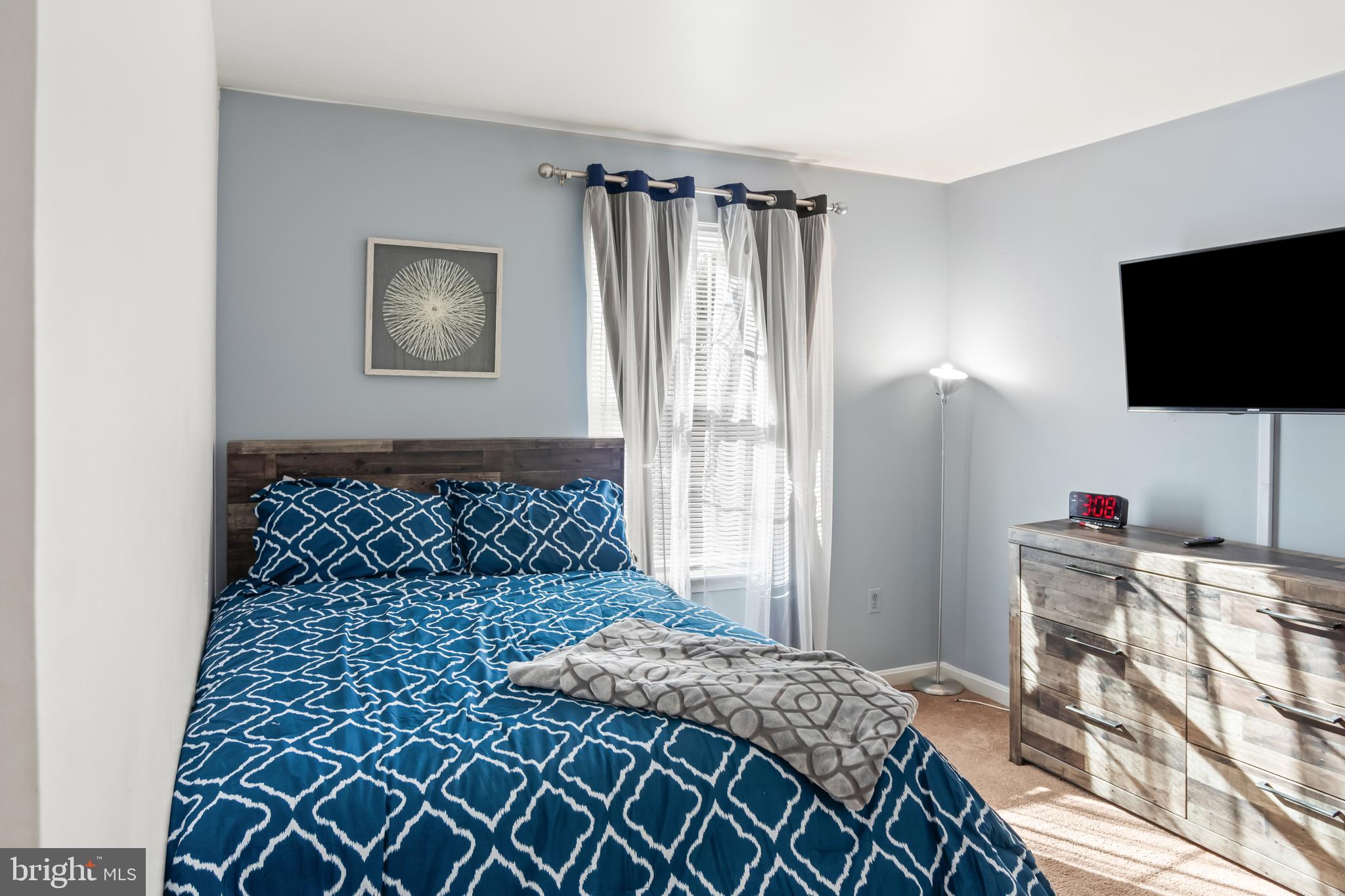 2230 Conquest Way Odenton, MD 21113 - Photo 35 of 47 a bedroom with a bed and a flat screen tv