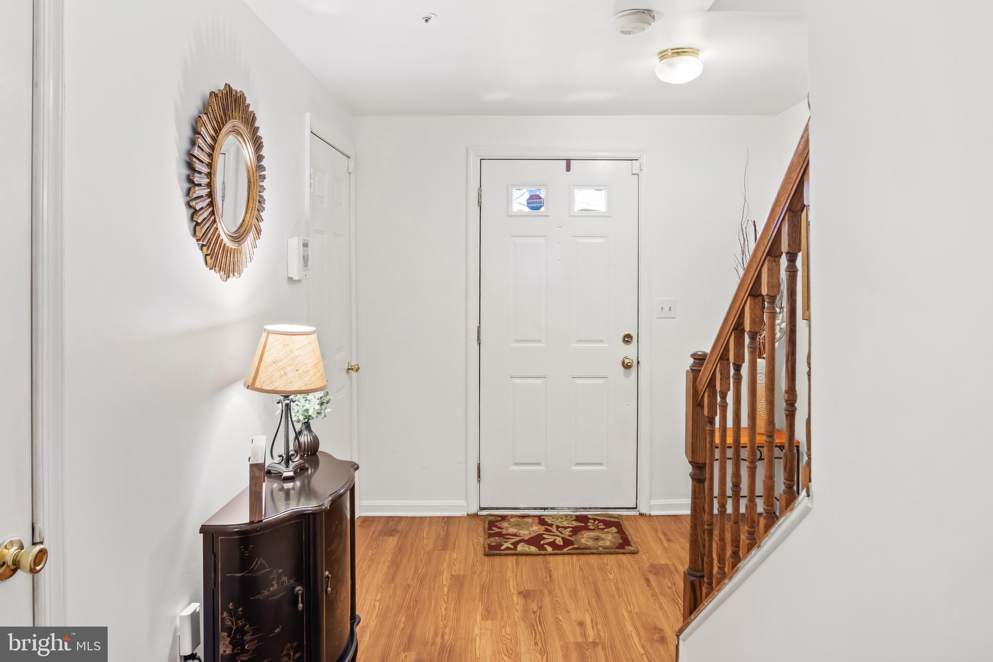 2230 Conquest Way Odenton, MD 21113 - Photo 6 of 47 a view of a hallway with wooden floor and staircase