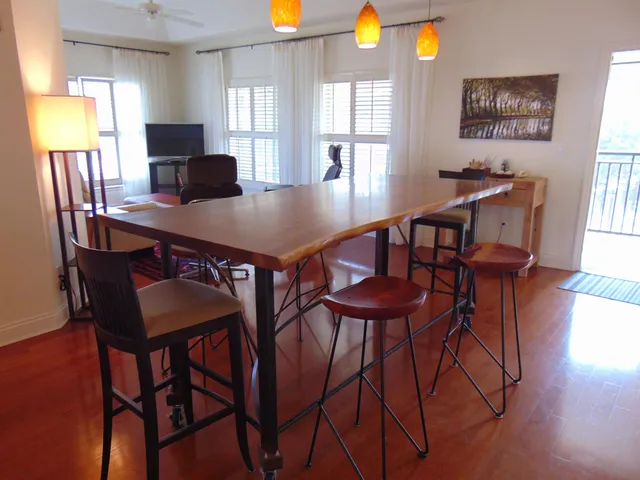 a view of a dining room with furniture and wooden floor