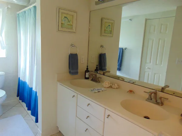 a bathroom with a double vanity sink and a mirror