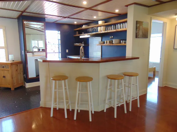 a kitchen with chairs and wood floor