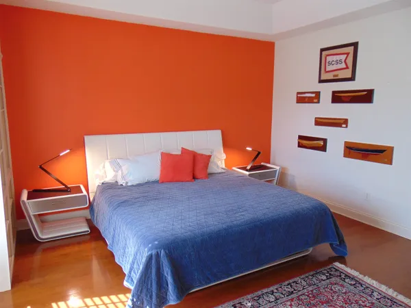 a bedroom with a bed and cupboard