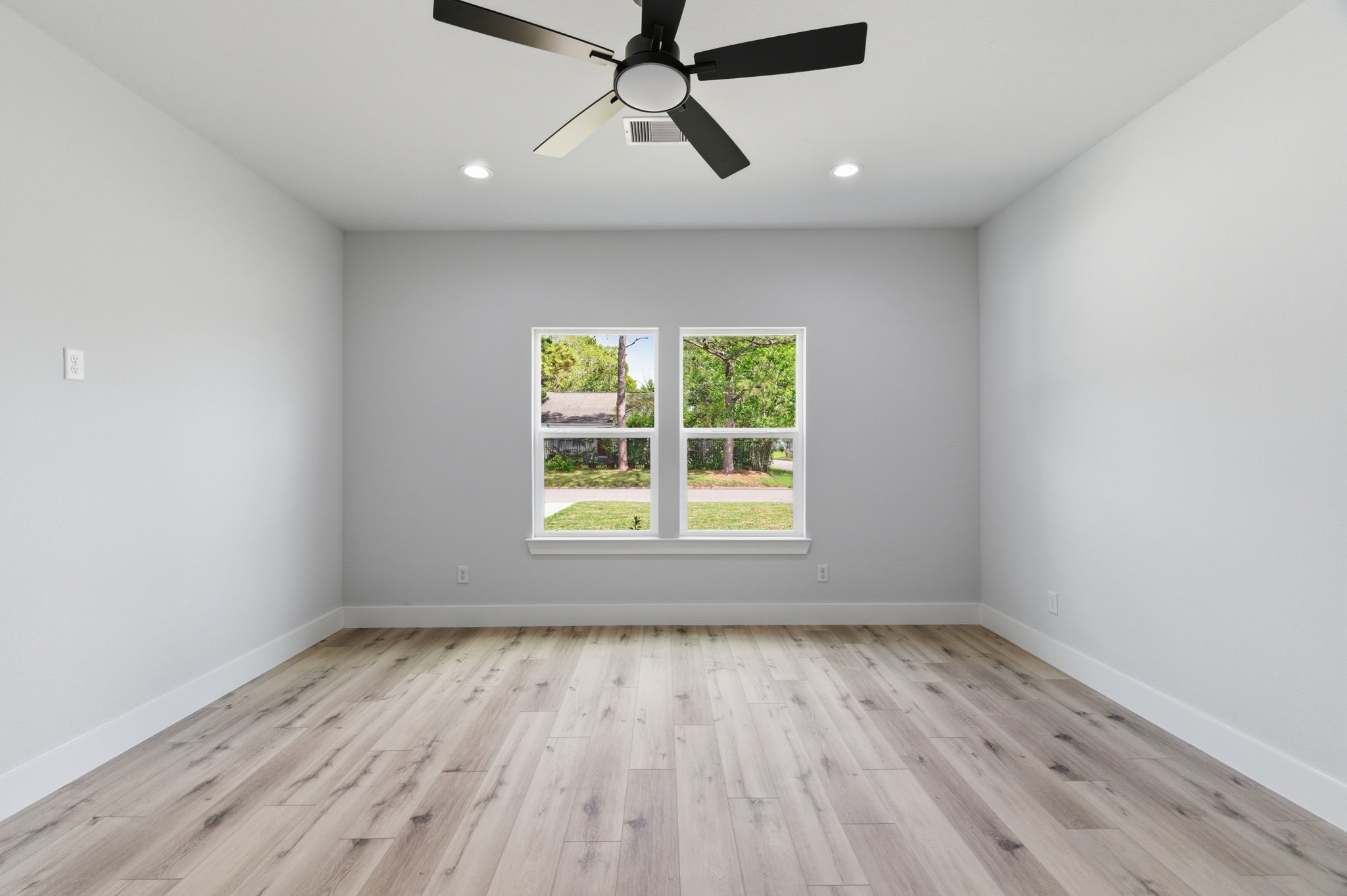 7040 Kinney Street Houston, TX 77087 - Photo 18 of 47 wooden floor in an empty room with a window