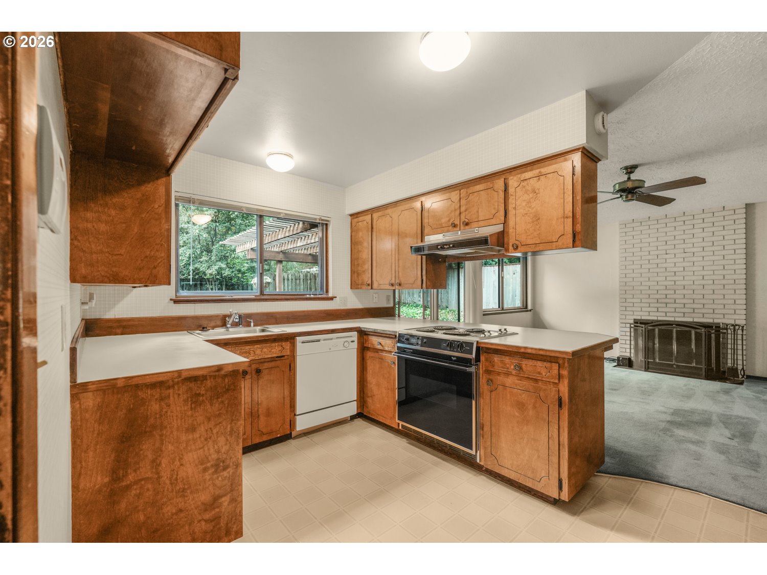 14155 Southwest 27th Street Beaverton, OR 97008 - Photo 10 of 27 a kitchen with stainless steel appliances granite countertop a stove a sink and a microwave