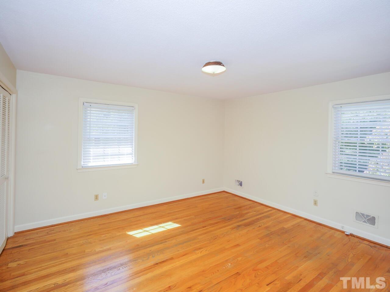2901 Mars Street Raleigh, NC 27604 - Photo 15 of 26 an empty room with wooden floor and windows