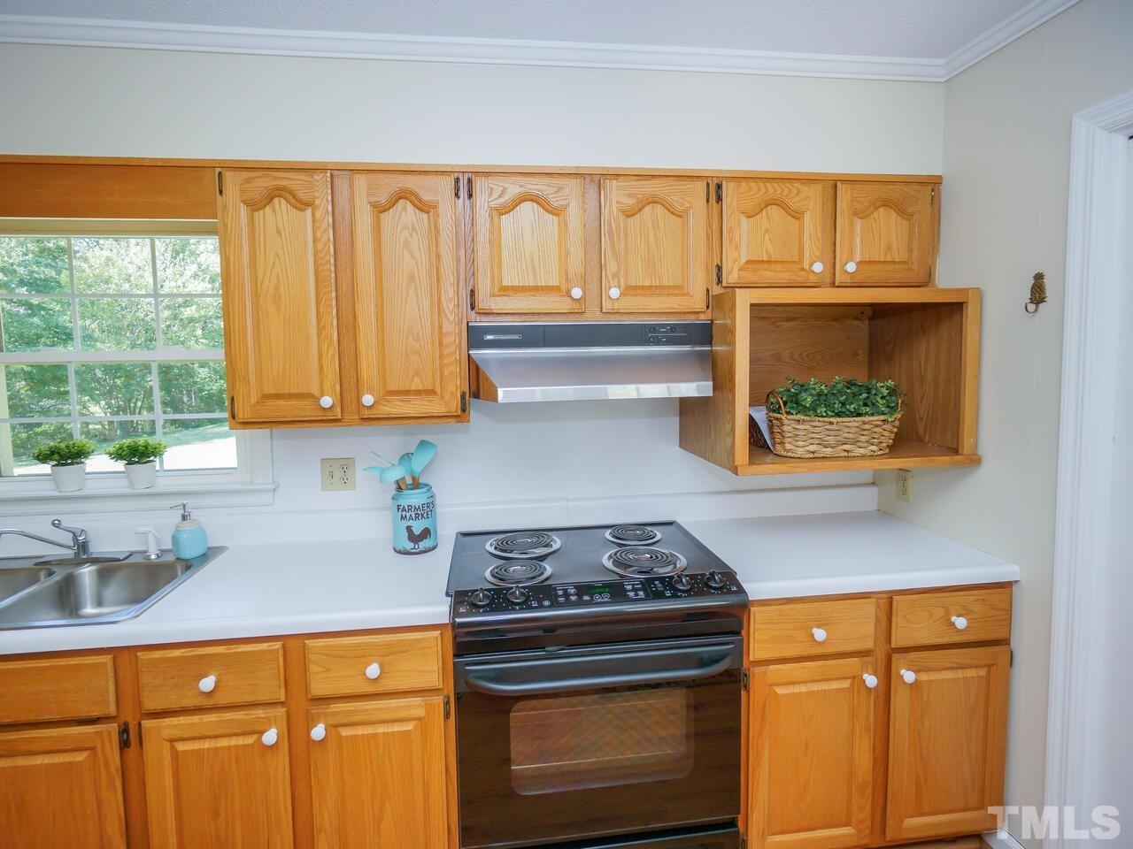 2901 Mars Street Raleigh, NC 27604 - Photo 8 of 26 a kitchen with stainless steel appliances wooden cabinets and a stove top oven