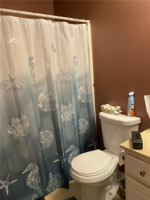 159 Windcroft Lane Northwest Acworth, GA 30101 - Photo 21 of 25 a white toilet sitting next to a shower curtain