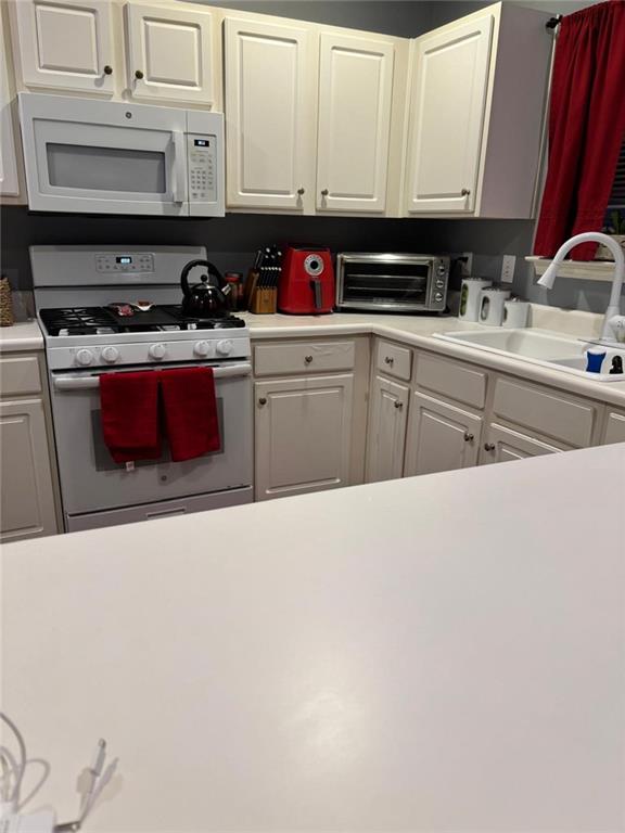 159 Windcroft Lane Northwest Acworth, GA 30101 - Photo 6 of 25 a kitchen with stainless steel appliances a sink a stove and cabinets