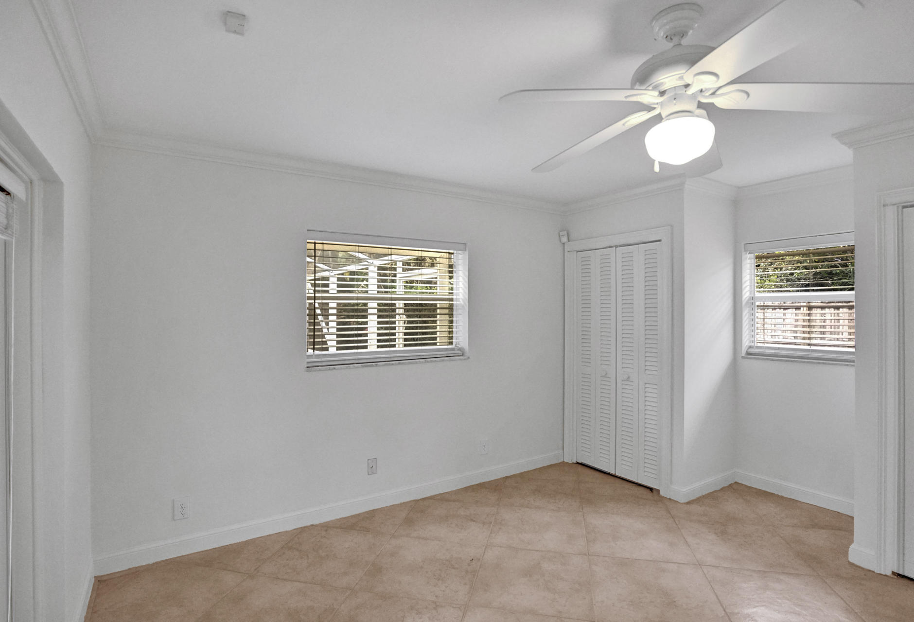 2016 Bethel Boulevard Boca Raton, FL 33486 - Photo 27 of 61 an empty room with windows and fan