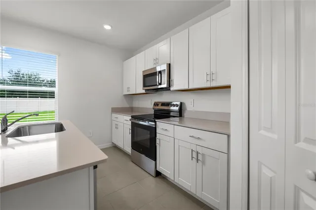 a kitchen with a sink stove and refrigerator