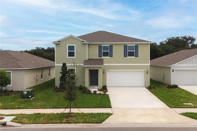 a front view of house with yard and green space