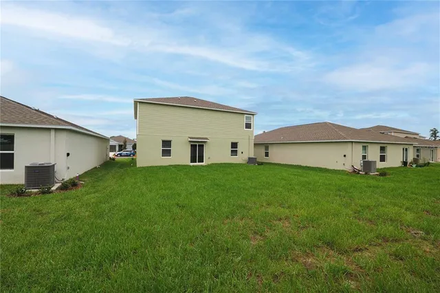 an aerial view of a house with a garden and a car parked
