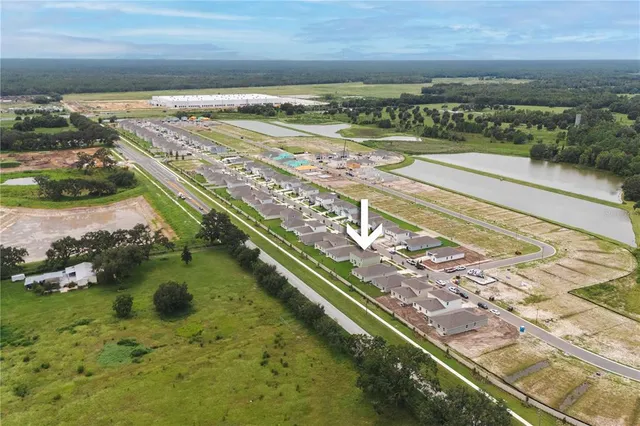 an aerial view of residential houses with outdoor space and street view
