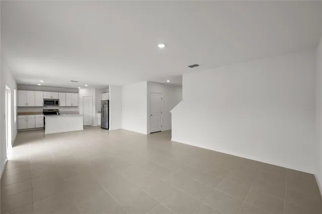 a view of a kitchen with a sink and a refrigerator