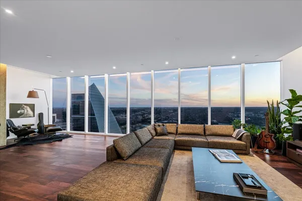 a living room with furniture gym equipment and a large window