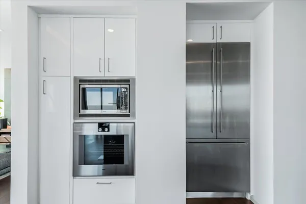 a kitchen with cabinets and stainless steel appliances
