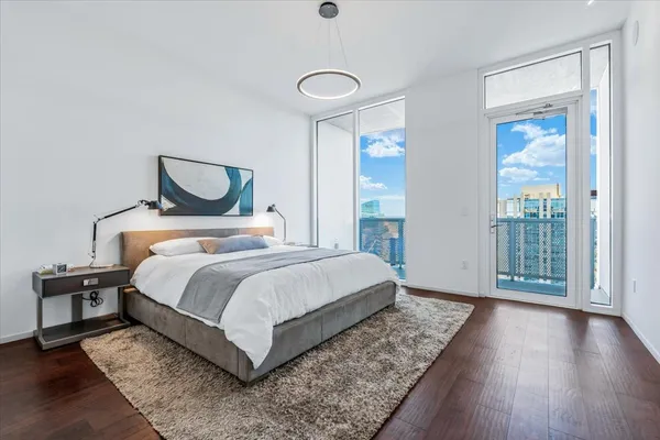 a bedroom with a bed and wooden floor