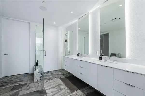 a bathroom with a double vanity sink and a mirror